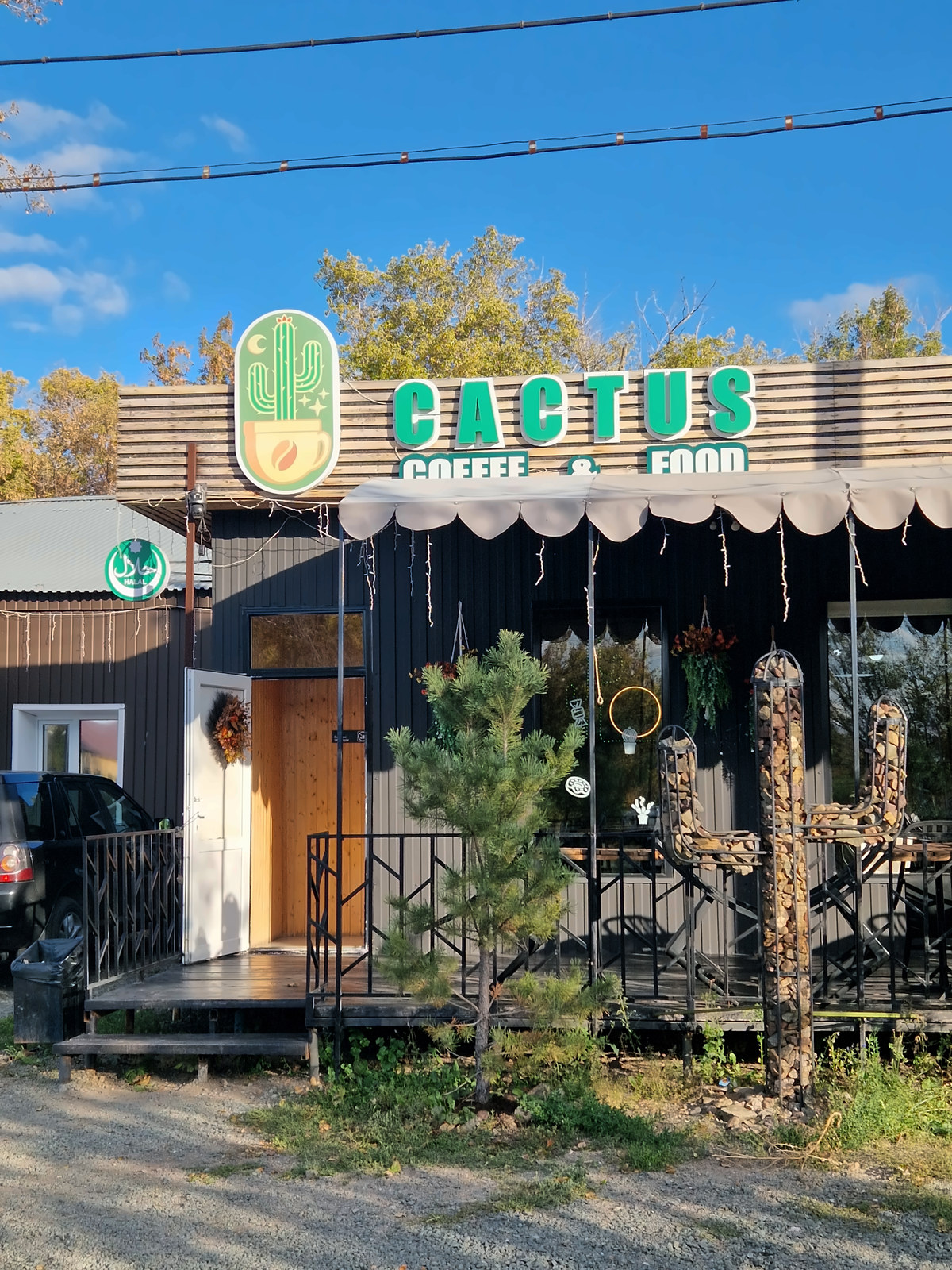 The front of a small café under a blue sky
