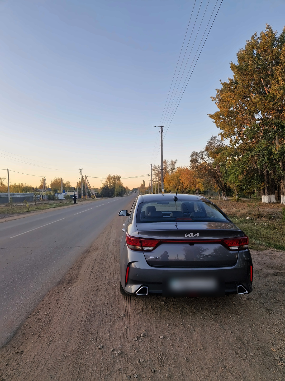 Our car parked on a roadside at sunset